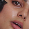 Woman applying Vitamin C serum