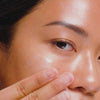 Woman applying ectoin serum