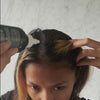 Woman applying scalp treatment