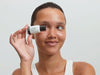 woman applying Hyaluronic acid serum