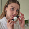 woman applying Hyaluronic Acid serum