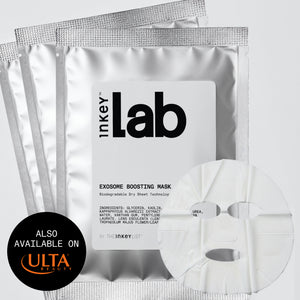 Three silver foil packets of inkey Lab Exosome Boosting Mask are arranged on a light gray background, with a white sheet mask partially visible in front and a black circular badge at lower left reading 'ALSO AVAILABLE ON ULTA BEAUTY'.