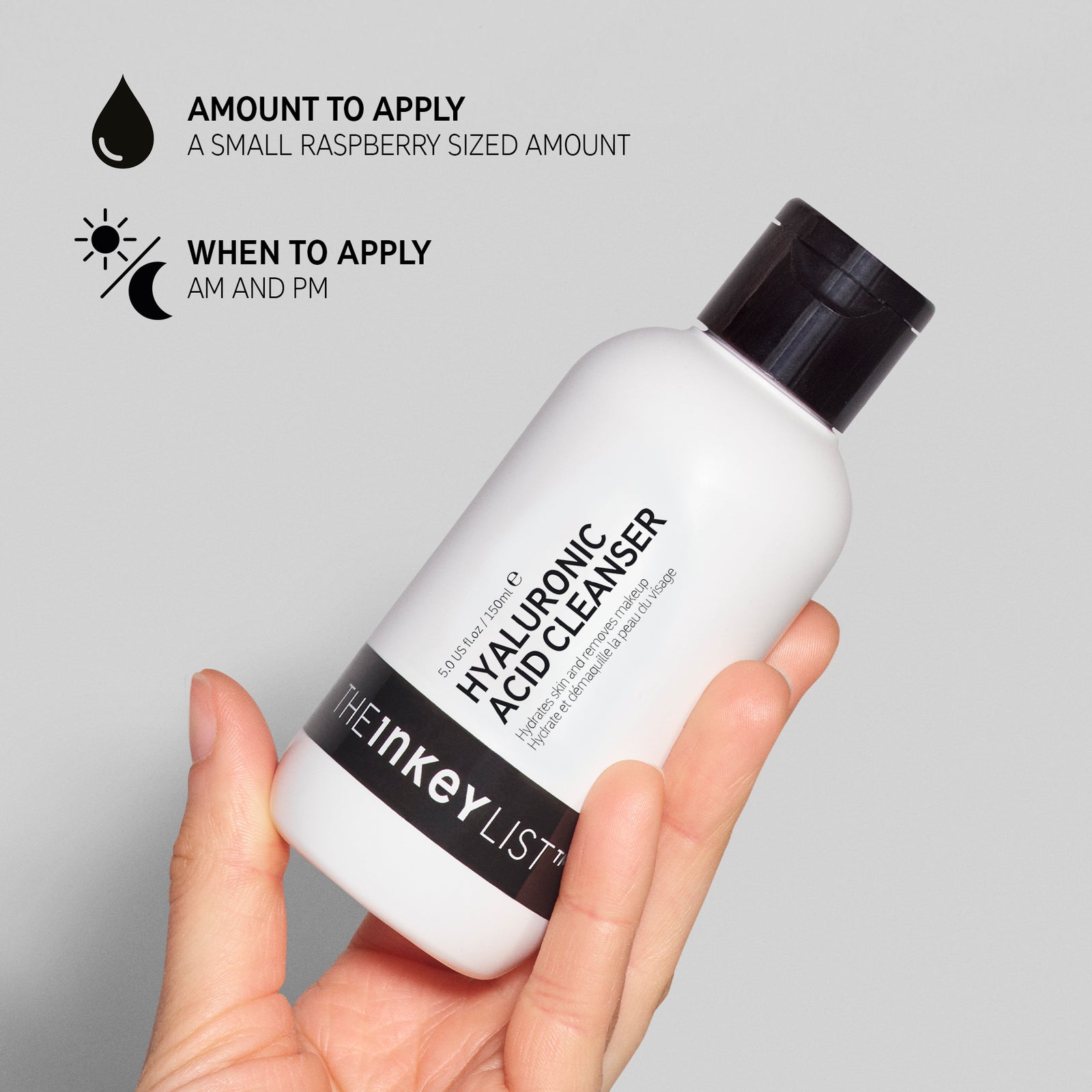 Hand holding Hyaluronic Acid Cleanser with black text explaining amount to apply (small raspberry sized amount)  and when to use it (AM and PM)