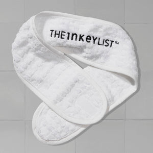 Image of The INKEY List Head Band against a white tiled bathroom background