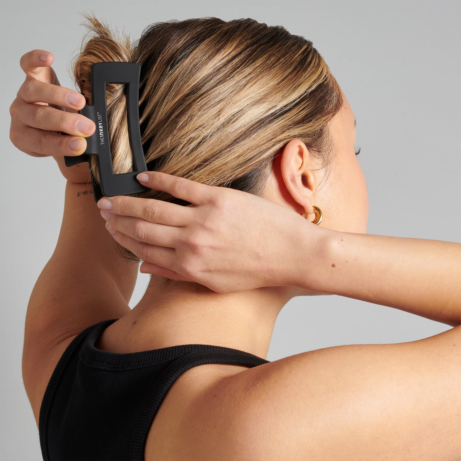 Image of a model using The INKEY List Hair Clip to clip back hair as part of their daily routine. 
