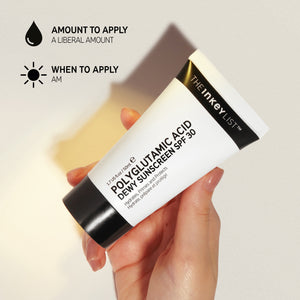 Polyglutamic Acid Dewy Sunscreen SPF 30 bottle held by model with application amount advice (a liberal amount) and when to apply (AM)