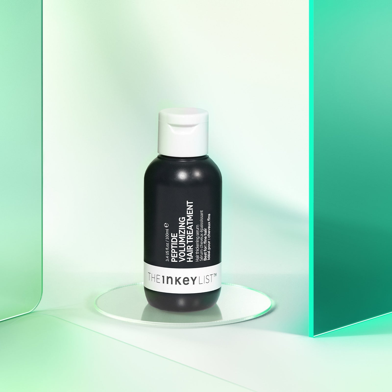 Peptide Volumizing Hair Treatment product against green background