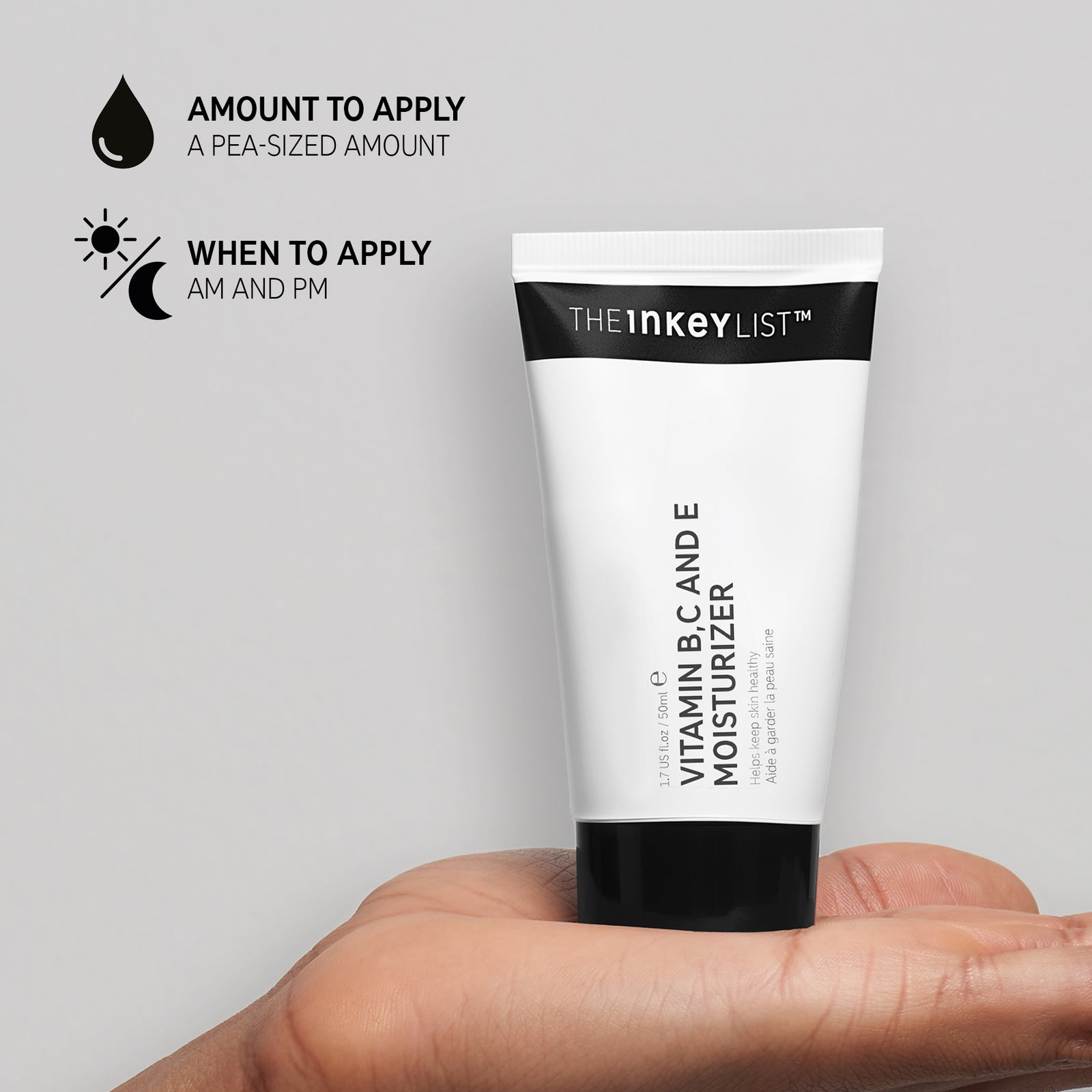 Hand holding Vitamin B, C and E Moisturizer against a grey background with black text that explains amount to apply (pea-szied amount) and when to use it in your routine (AM and PM)