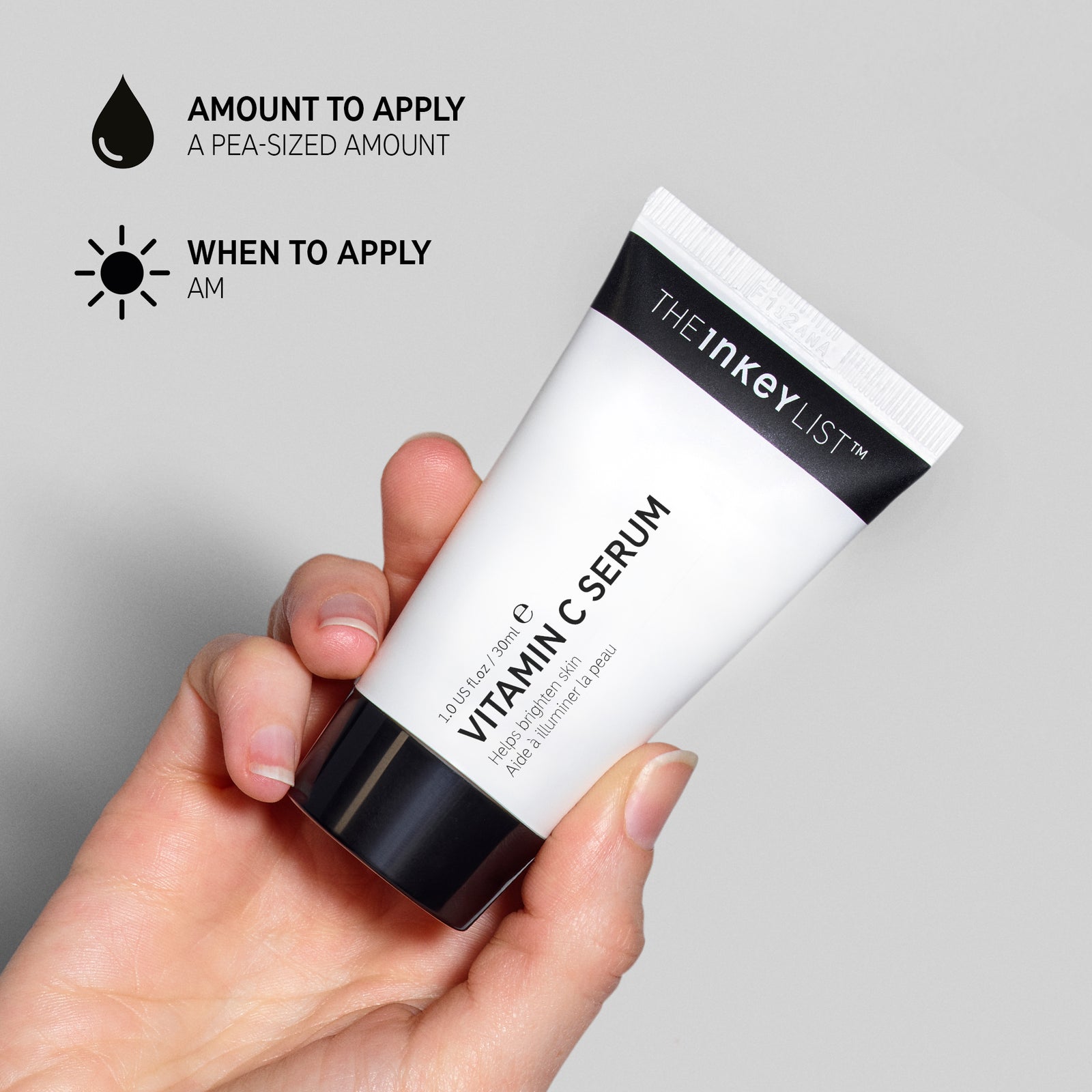Hand holding a tube of Vitamin C Serum with text overlay explaining amount to apply (pea-sized amount) and when to use it in your skincare routine (AM only)