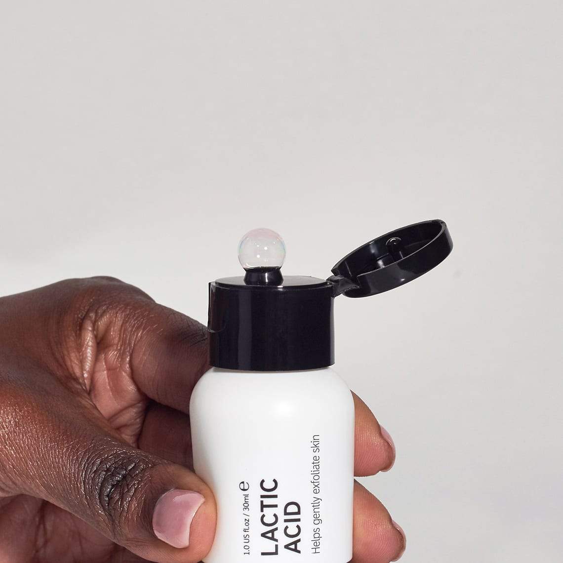 Lactic Acid bottle being squeezed